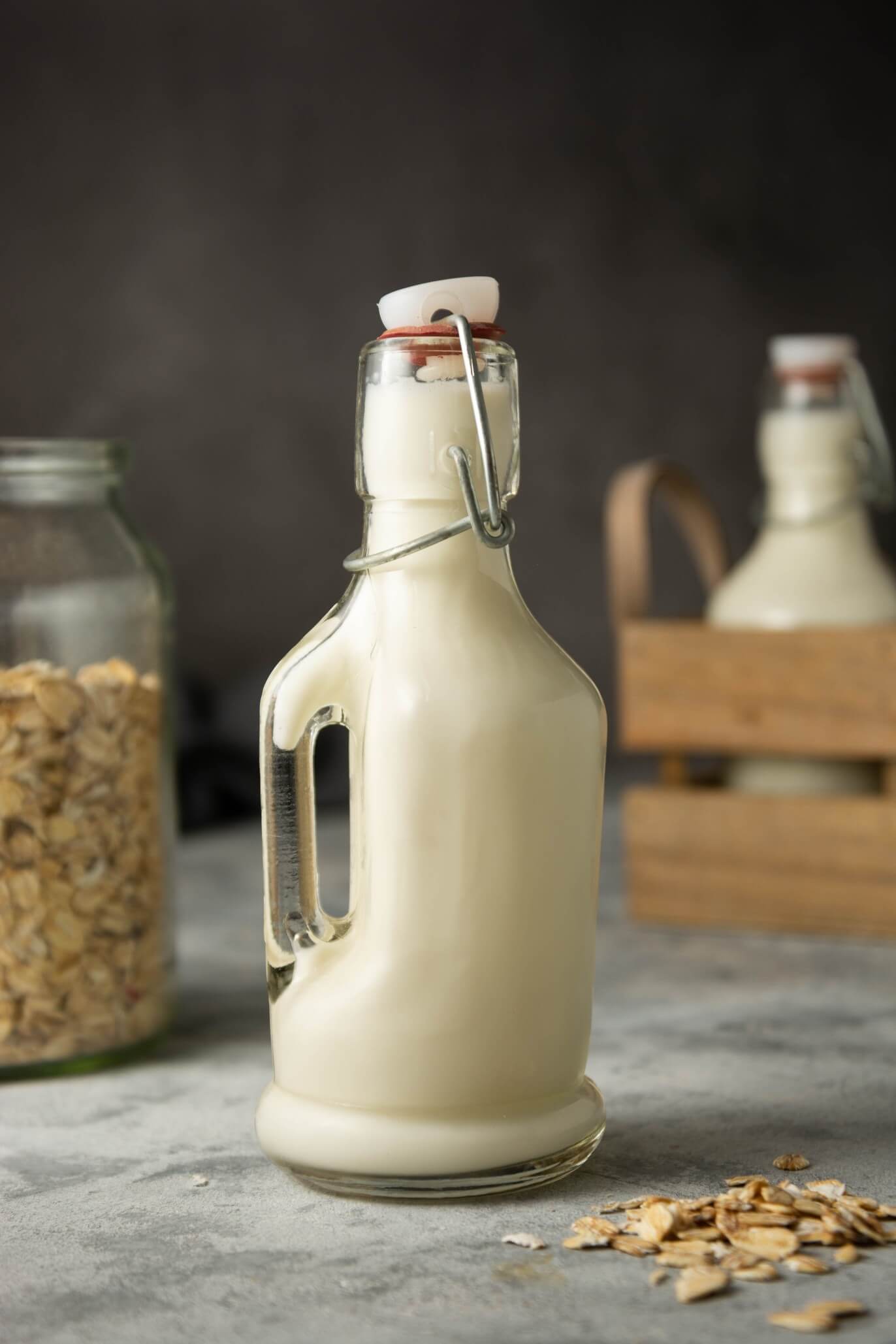oat milk in glass bottle with rustic background
