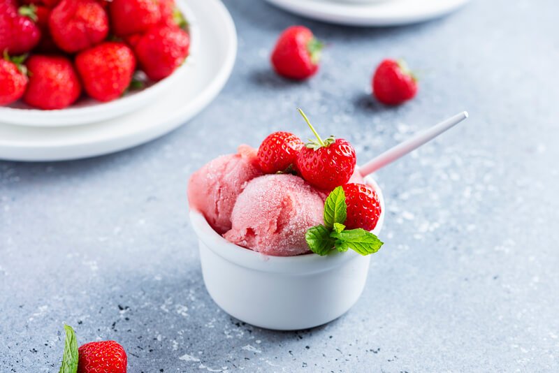 cup of sorbet with strawberries on top