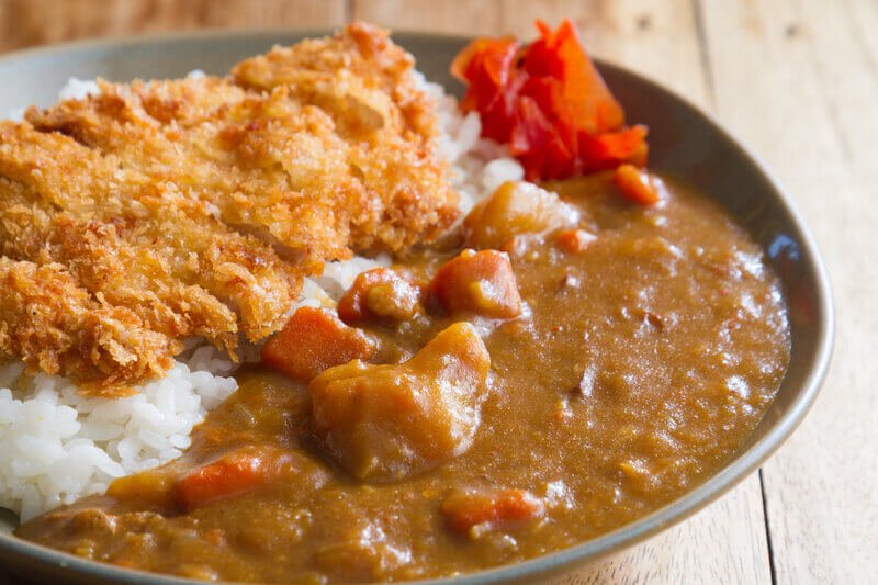 japanese curry with rice and fried pork on plate