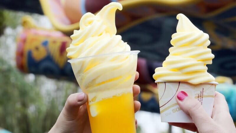 two hands holding dole whips