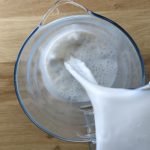 pouring vanilla almond milk in pitcher