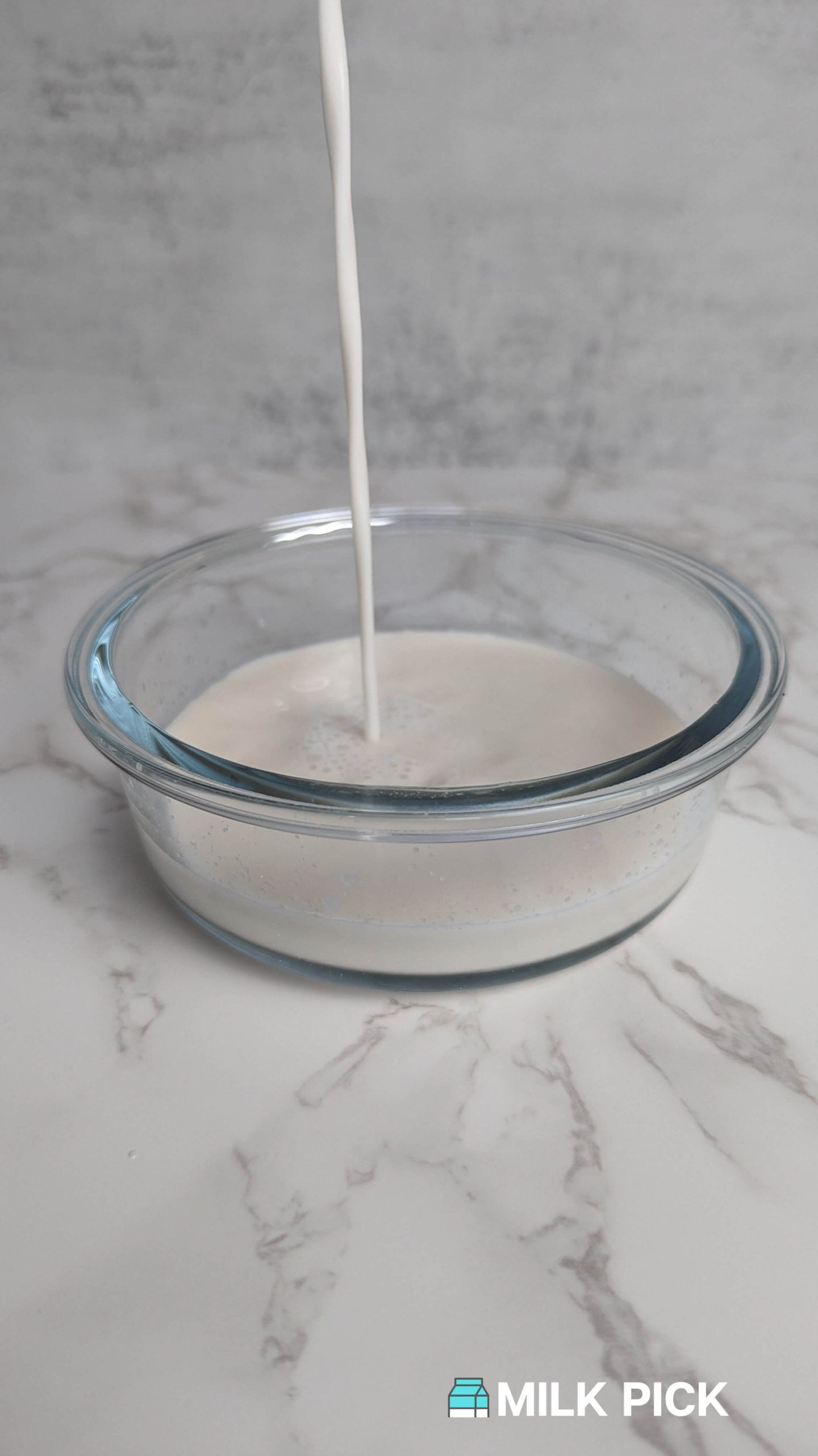 almond milk pouring into glass container