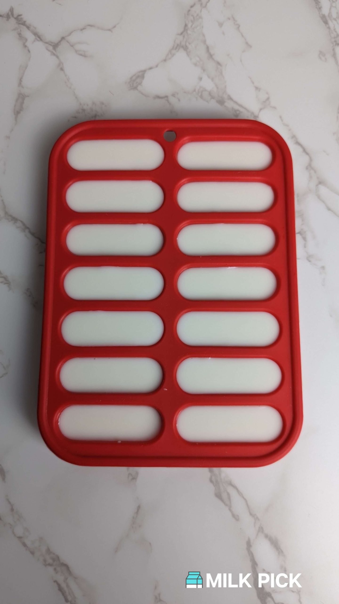 ice cube tray filled with almond milk