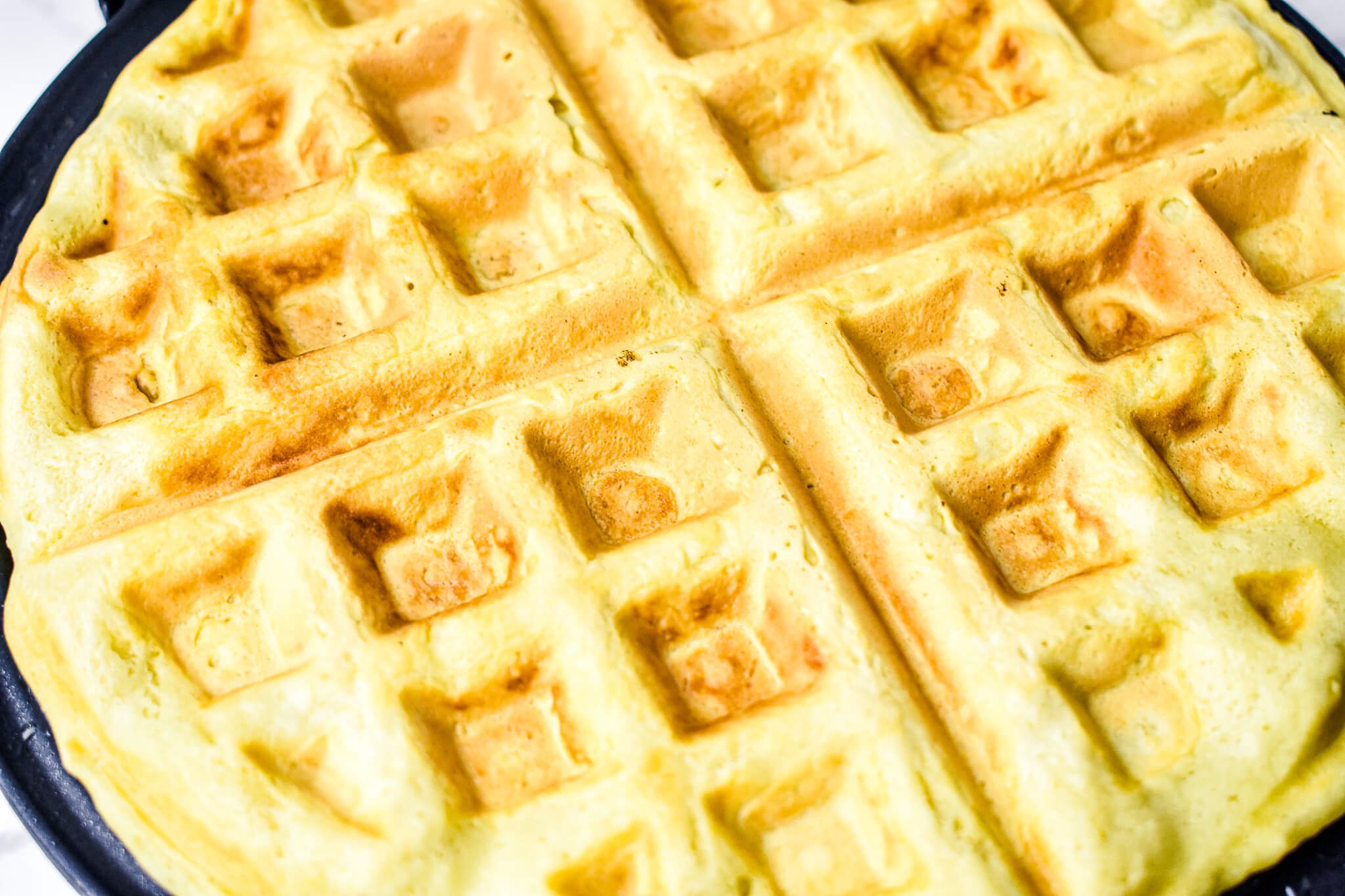 almond milk waffle on waffle iron closeup