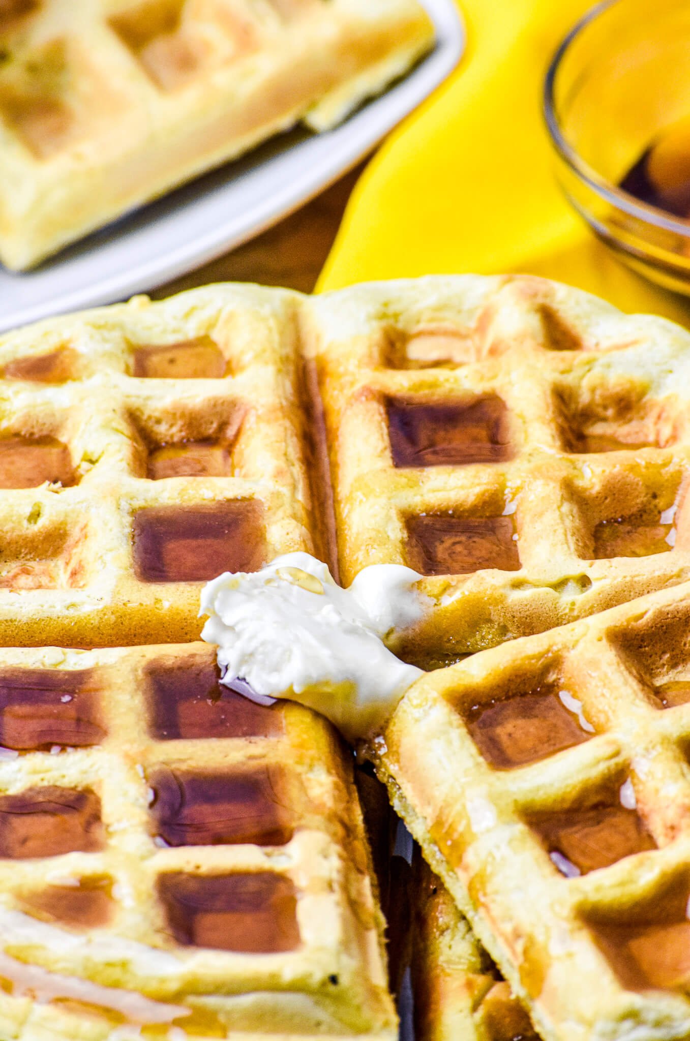 closeup almond milk waffle with vegan butter and syrup