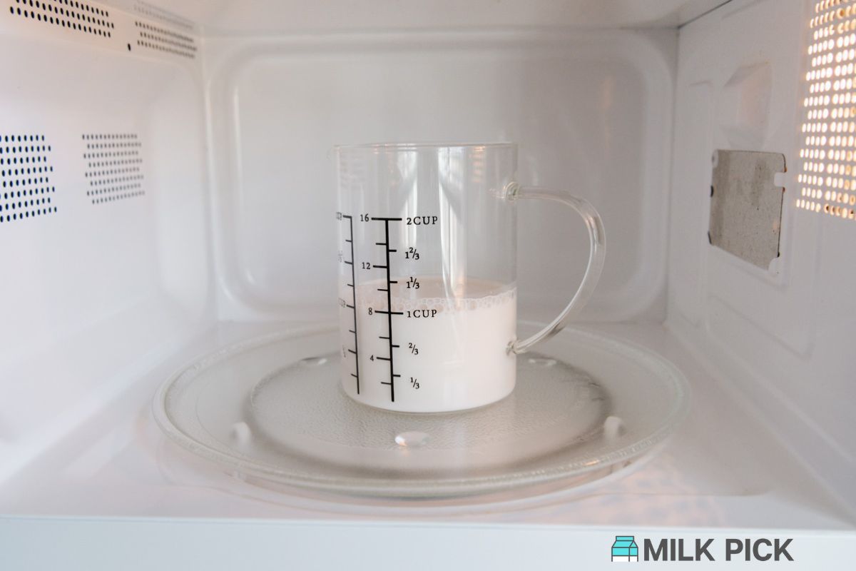 cup of almond milk in microwave