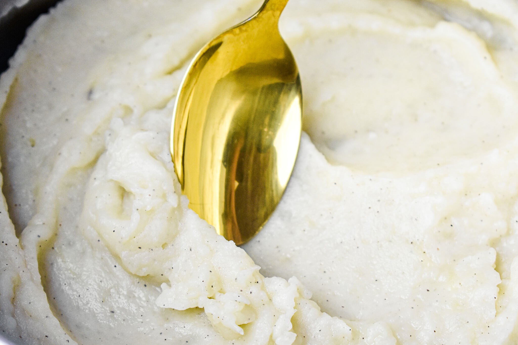gold spoon in almond milk mashed potatoes