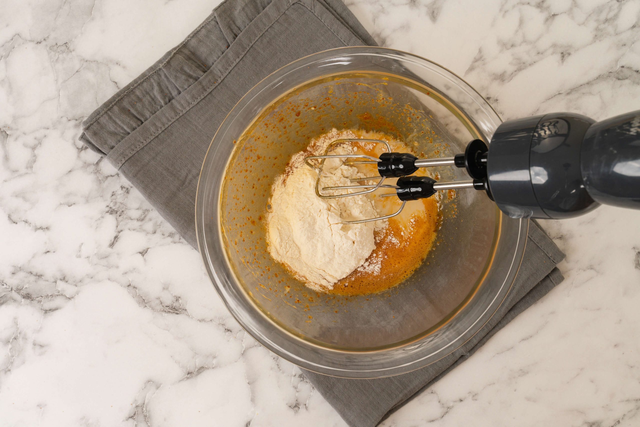 adding flour to almond milk pancake batter