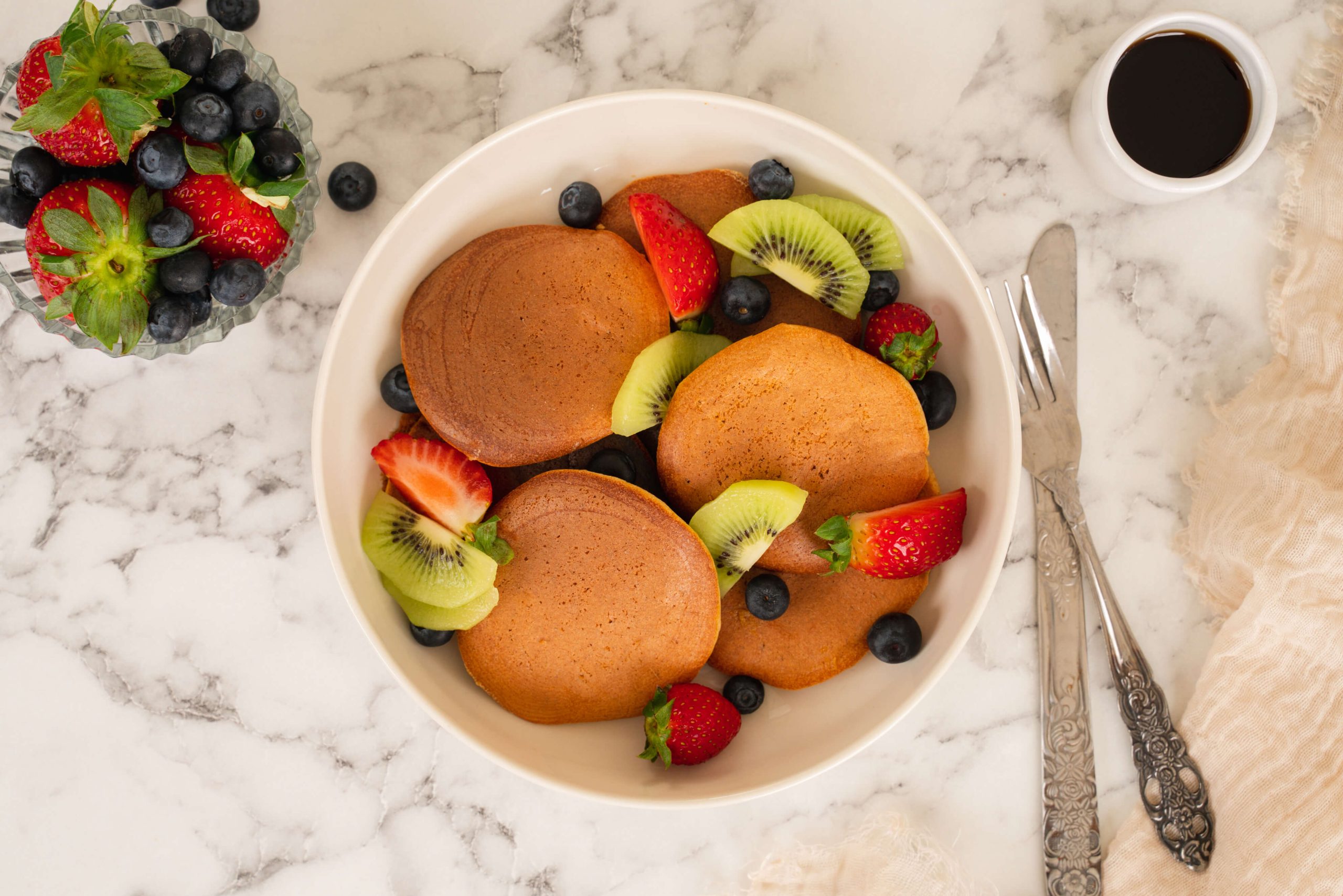 almond milk pancakes in bowl with fruit
