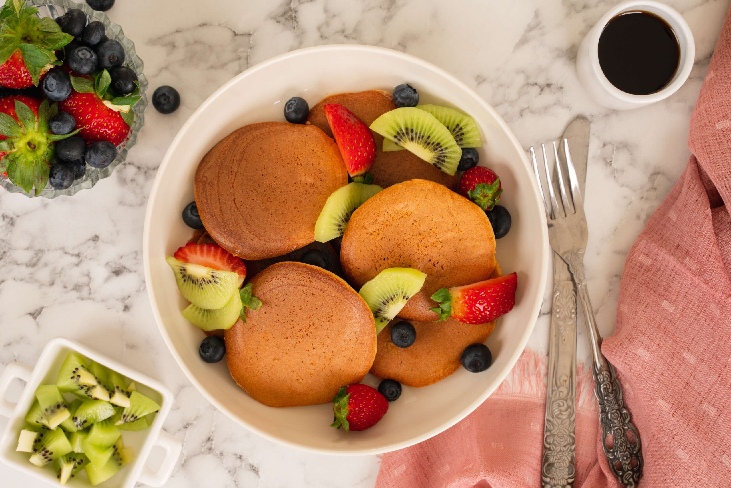 almond milk pancakes in bowl with mixed fruits