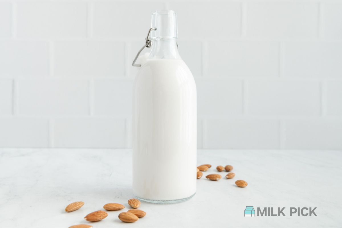 bottle of almond milk on countertop white background