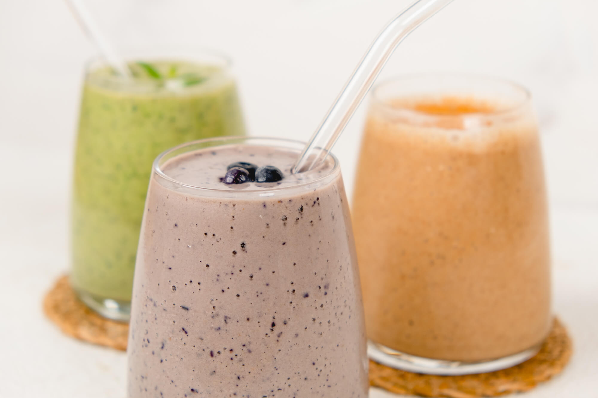 closeup of berrylicious almond milk smoothie with glass straw