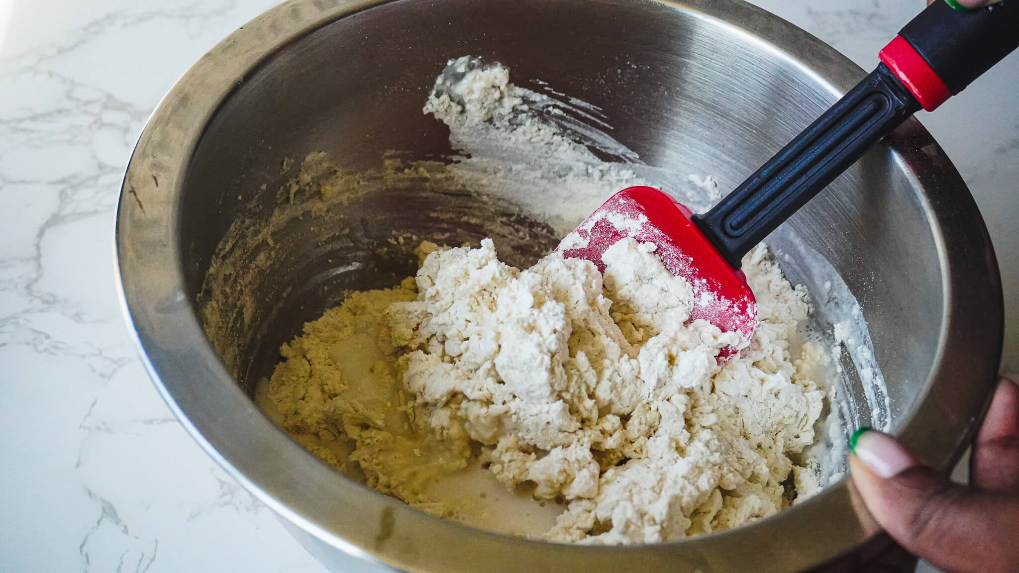 mixing almond milk biscuit ingredients in bowl