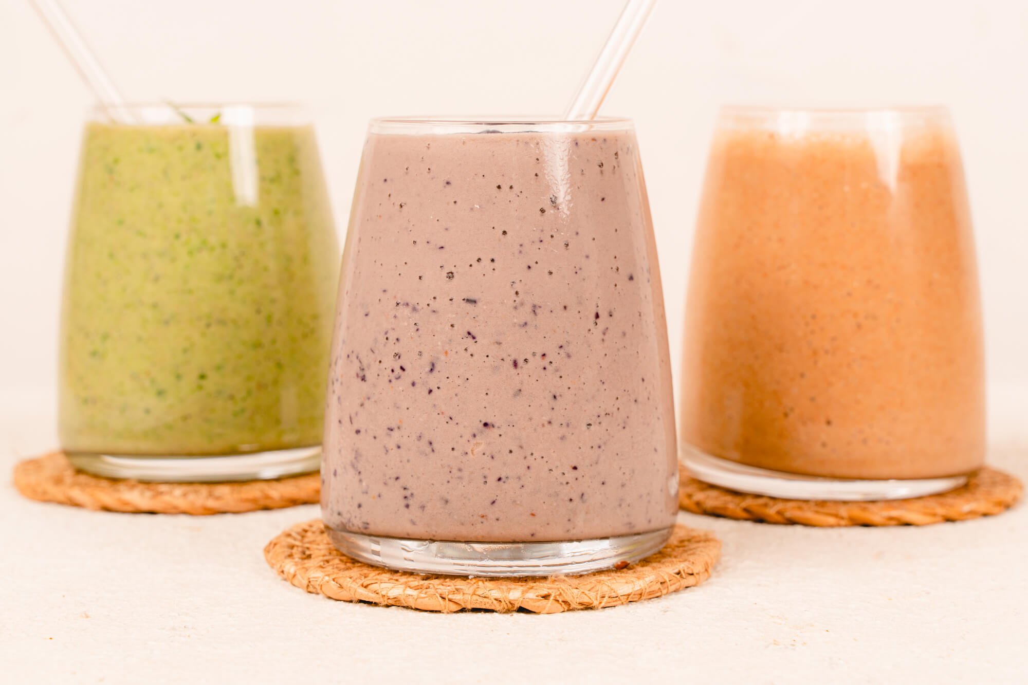three types of almond milk smoothies in glasses