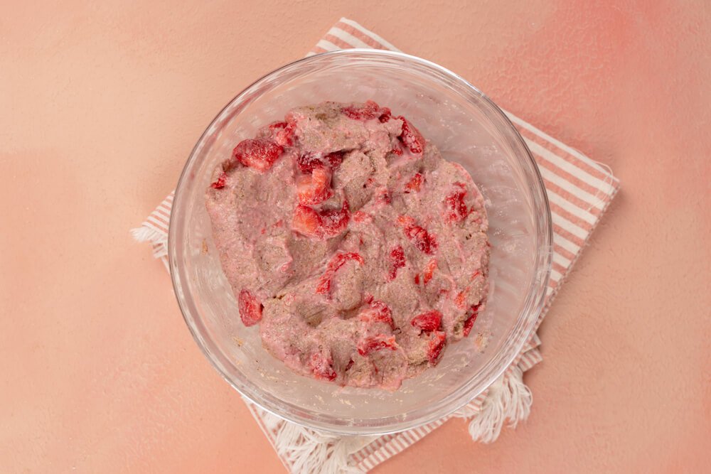 mixing strawberries in dairy-free scone dough