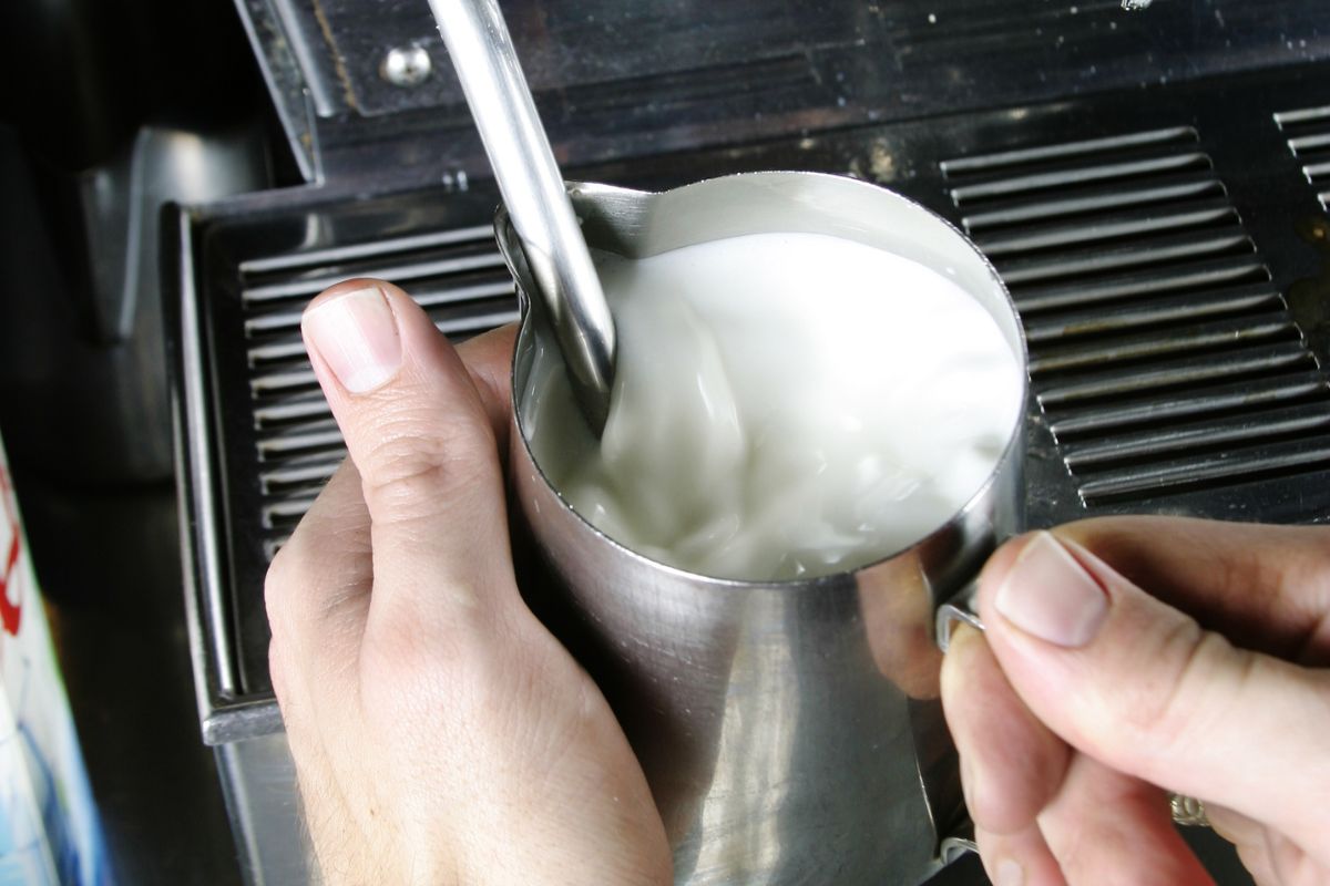 frothing oat milk with steam wand